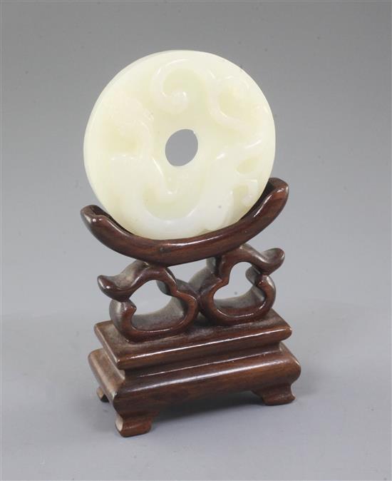 A Chinese white jade bi disc, diameter 4.6cm, wood stand